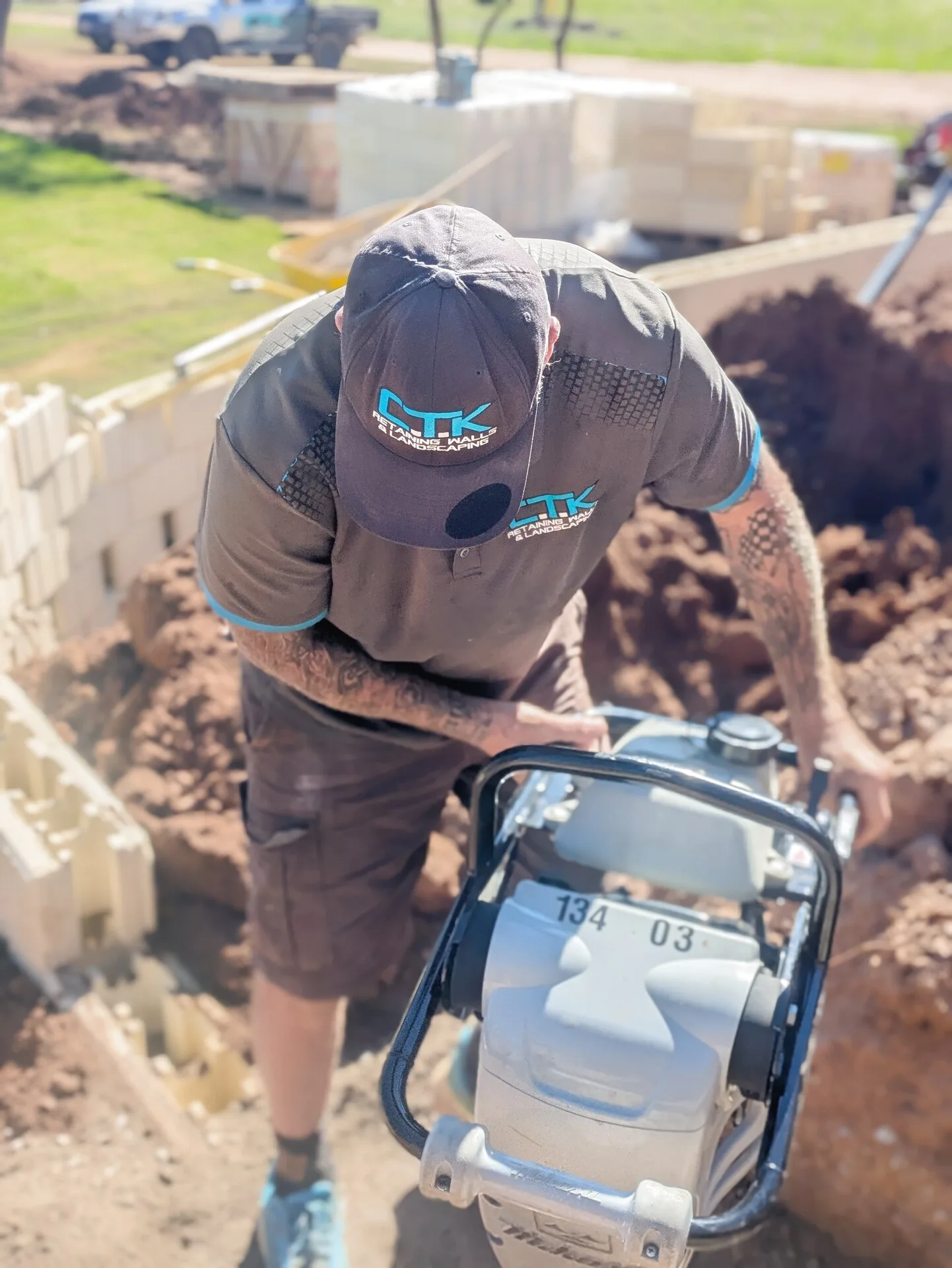 CTK team member operating plate compactor on site