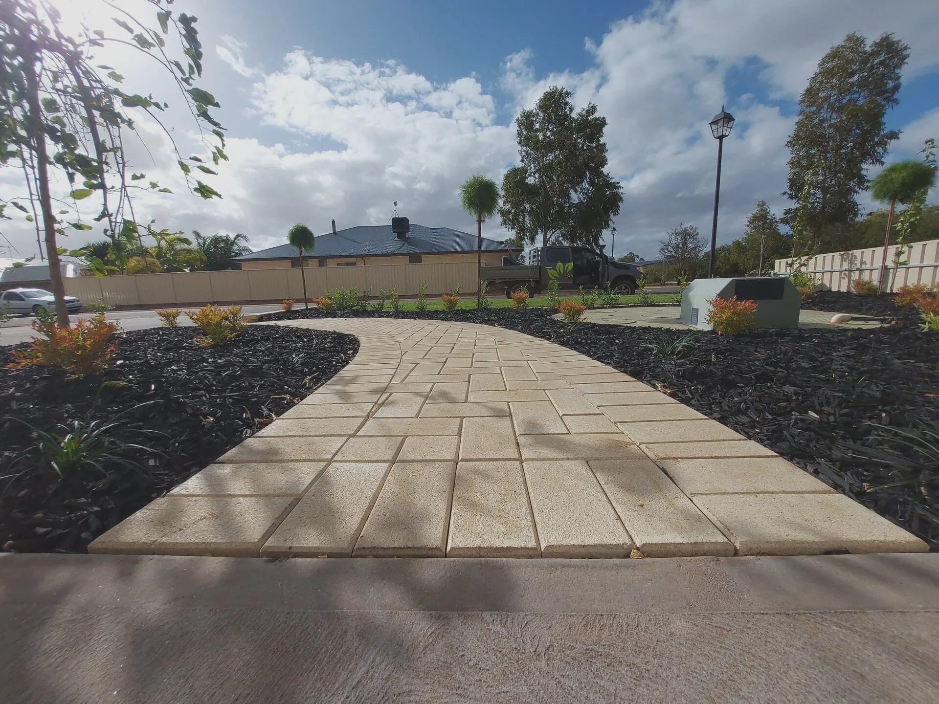 Gently curved paver path through a garden setting