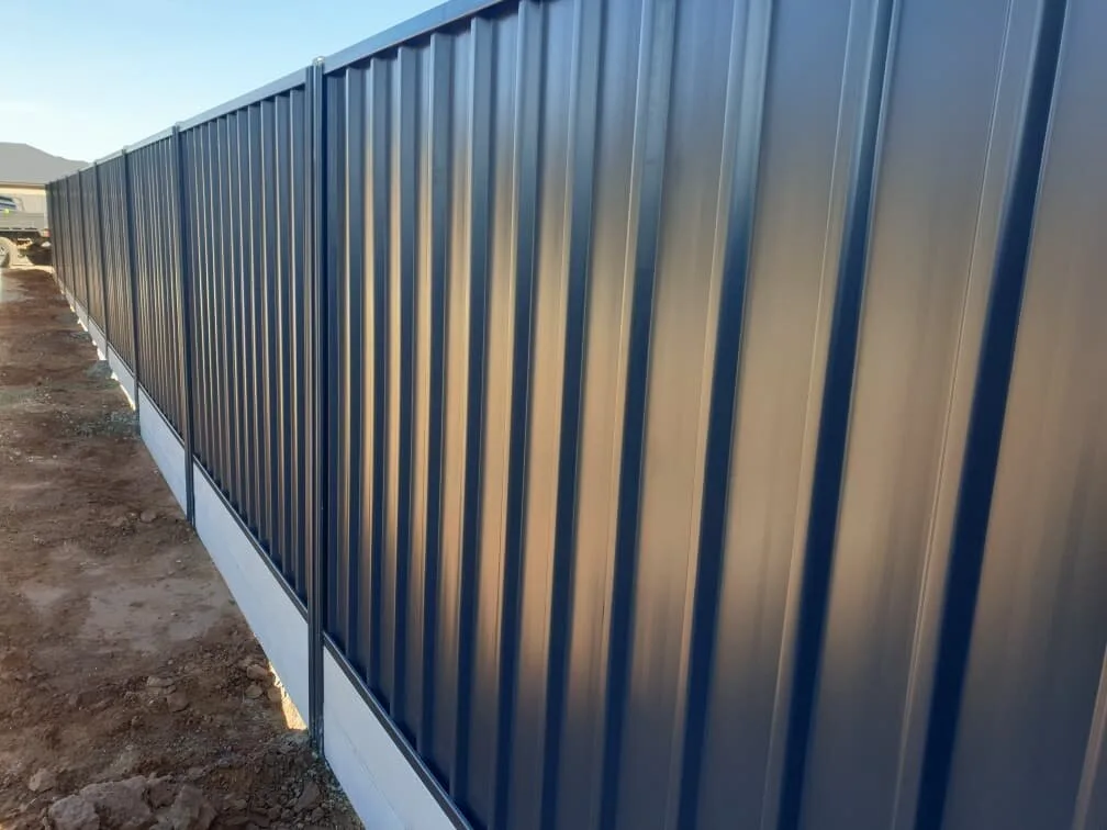 Timber sleeper retaining wall adjacent to colorbond fencing, Gawler